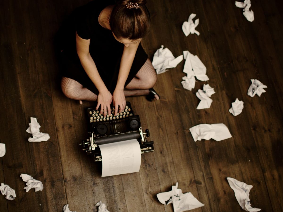 woman writing on typewriter